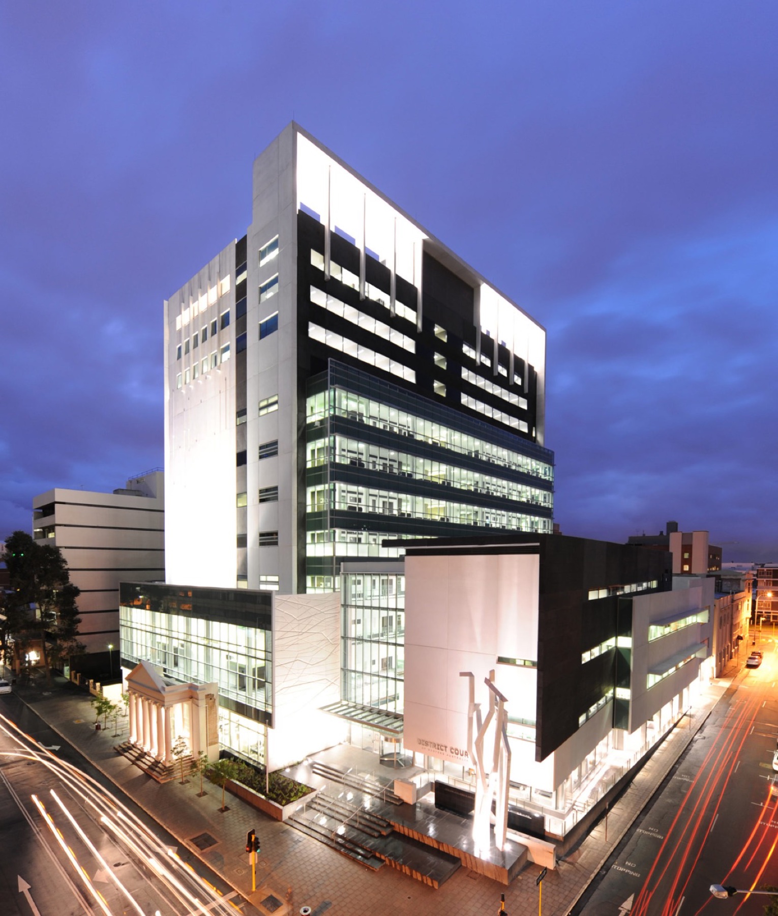 Perth's civic and courts precinct illuminated at dusk