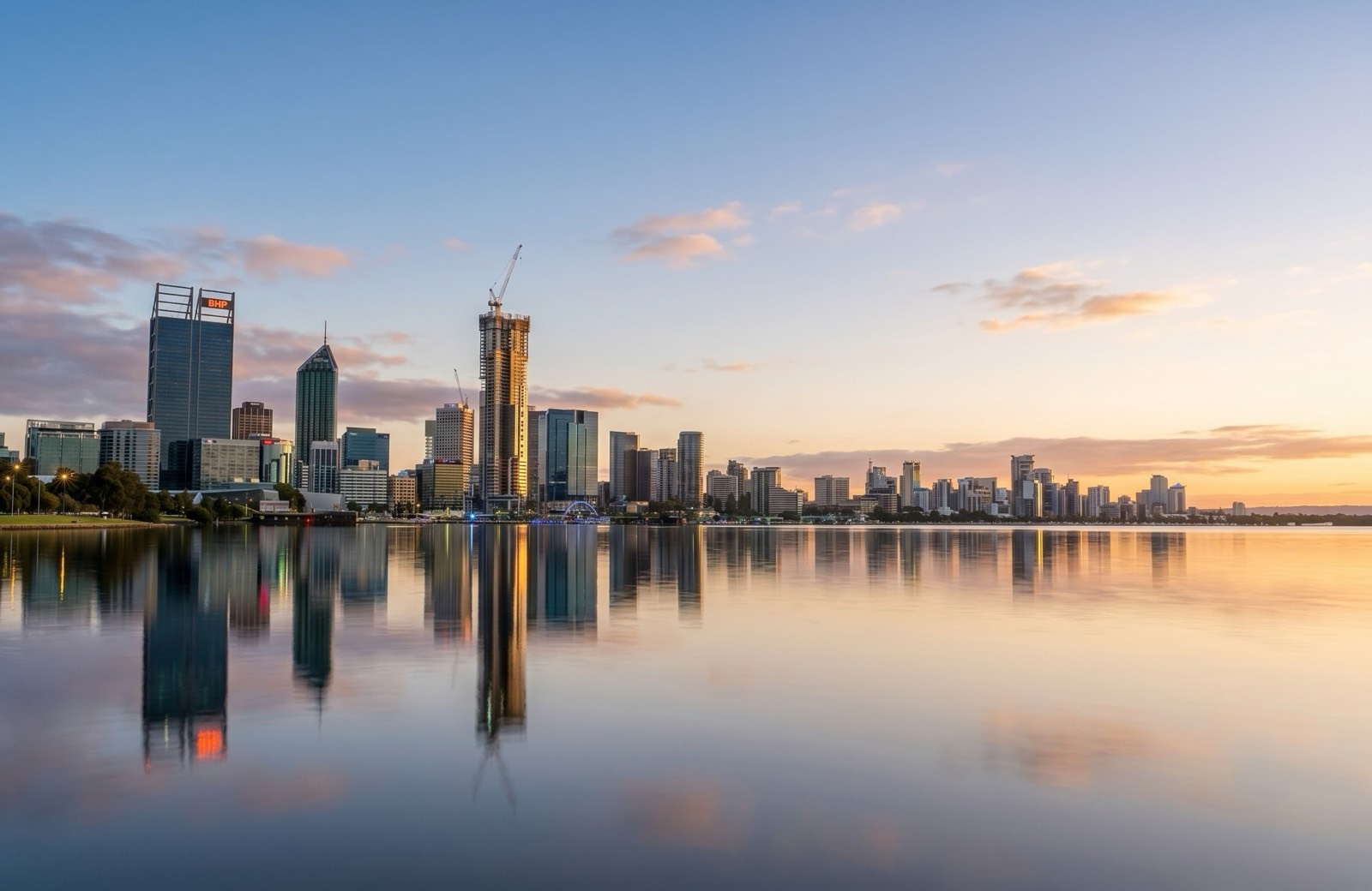 The Perth CBD skyline reflected across the Swan River at dusk
